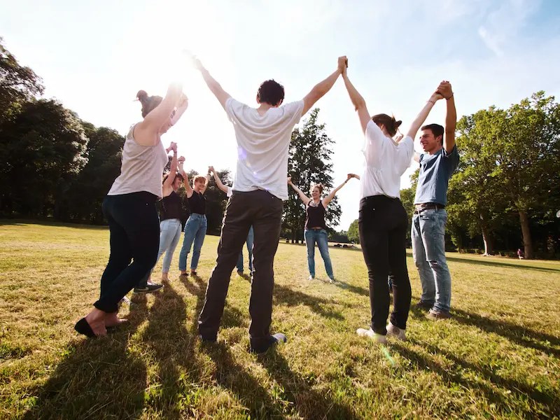 Members of a supported teaching staff participate in outdoor group activities. 