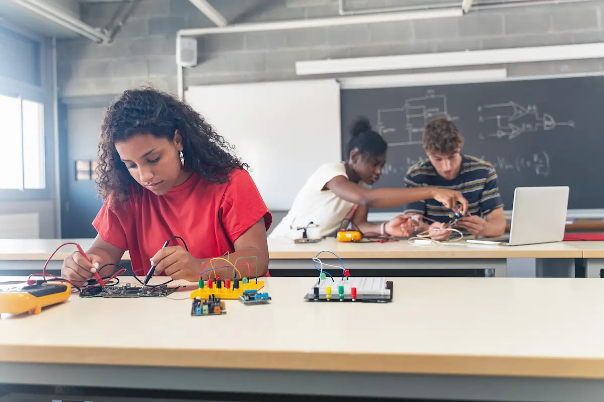 Diverse group of teenaged students learning STEM in the classroom.