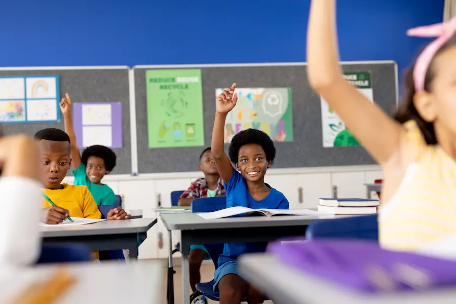 African American children enthusiastically learn about Juneteenth in the classroom.
