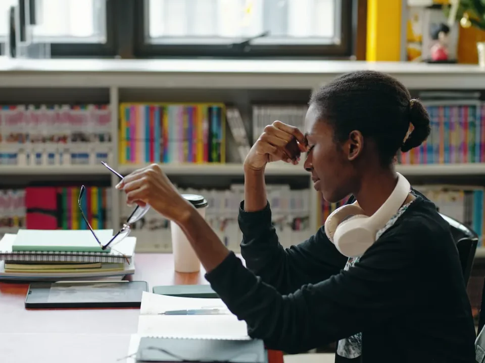 Young female teacher visibly frustrated and dealing with teacher burnout.