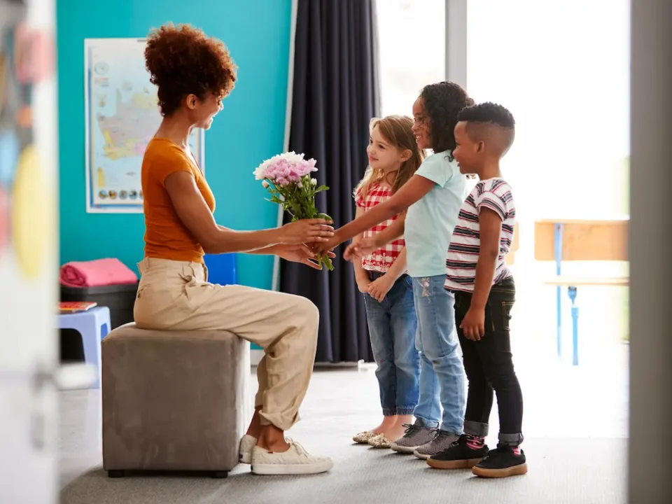 A class of elementary students shows appreciation to the teacher