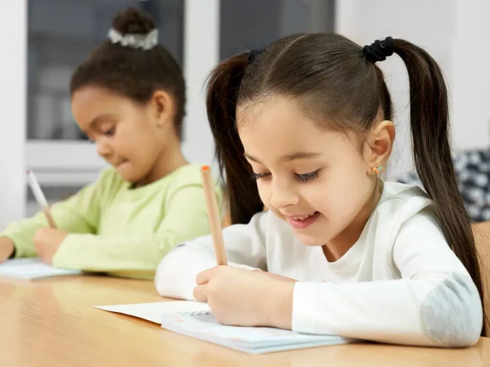 Young girls write in their planners for National Planner Day.