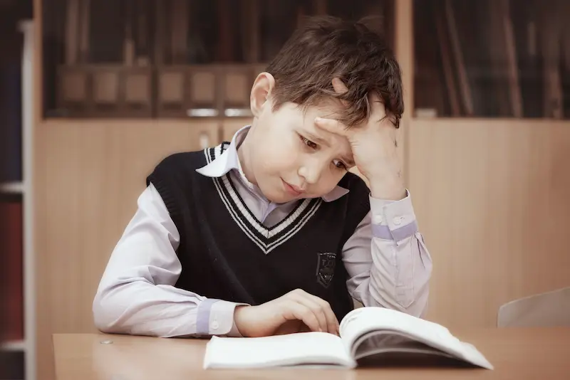 A student who struggles with reading looks frustrated.