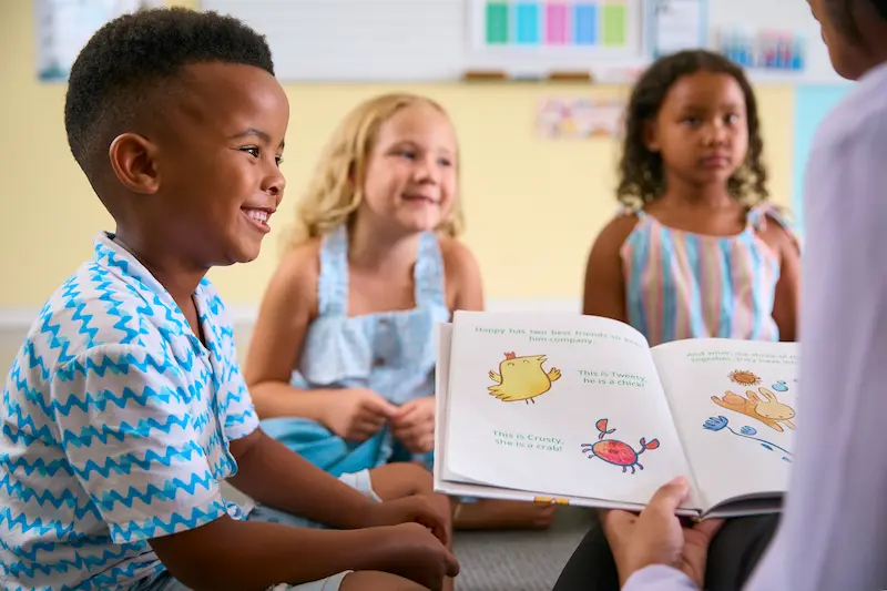 A teacher reads to young students for National Book Month. 