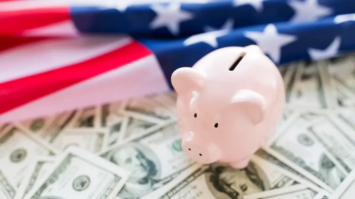 Piggy bank resting on top of money with an American flag in the background