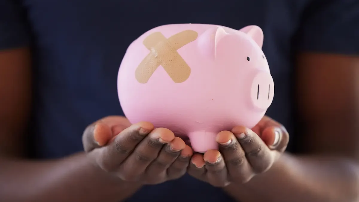 A broken piggy bank with a bandage.