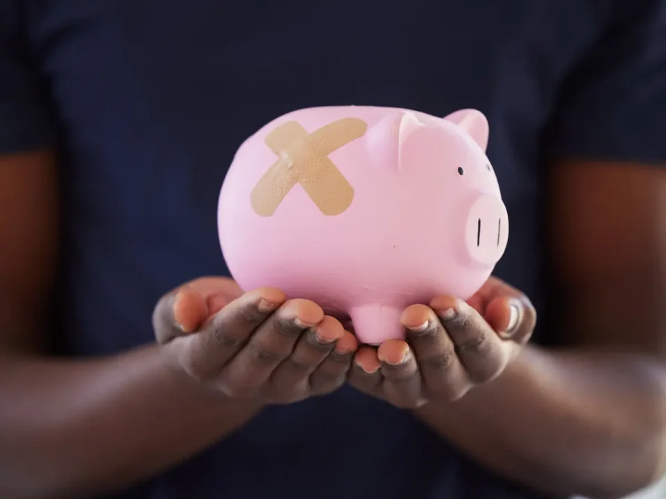 A broken piggy bank with a bandage.