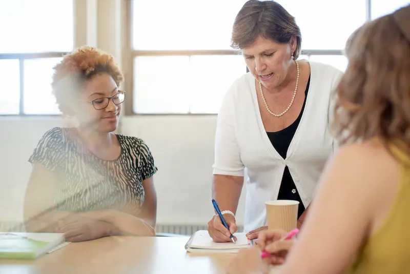 A group of women meets to give constructive feedback.