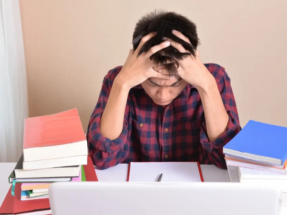 Student stressed while studying for test.