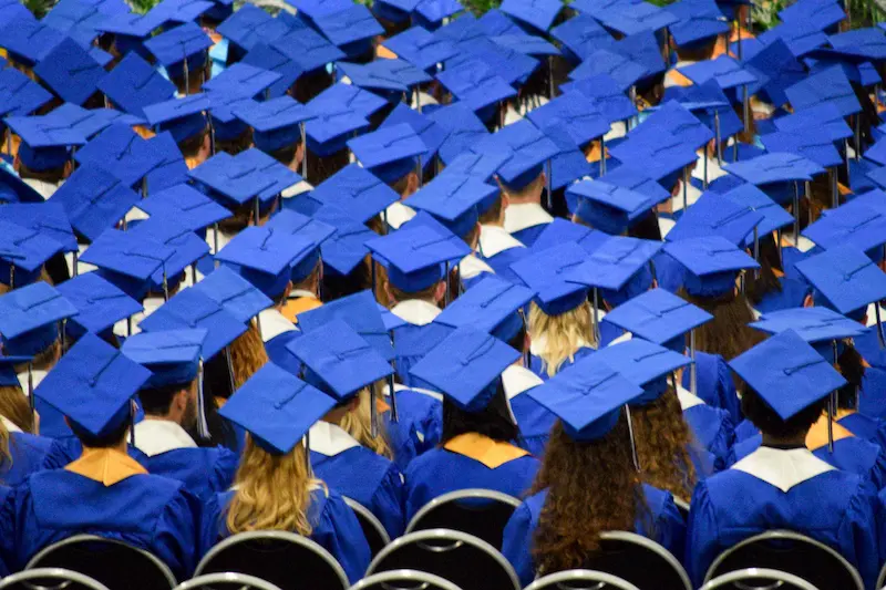 A view from behind of graduates in cap and gown 